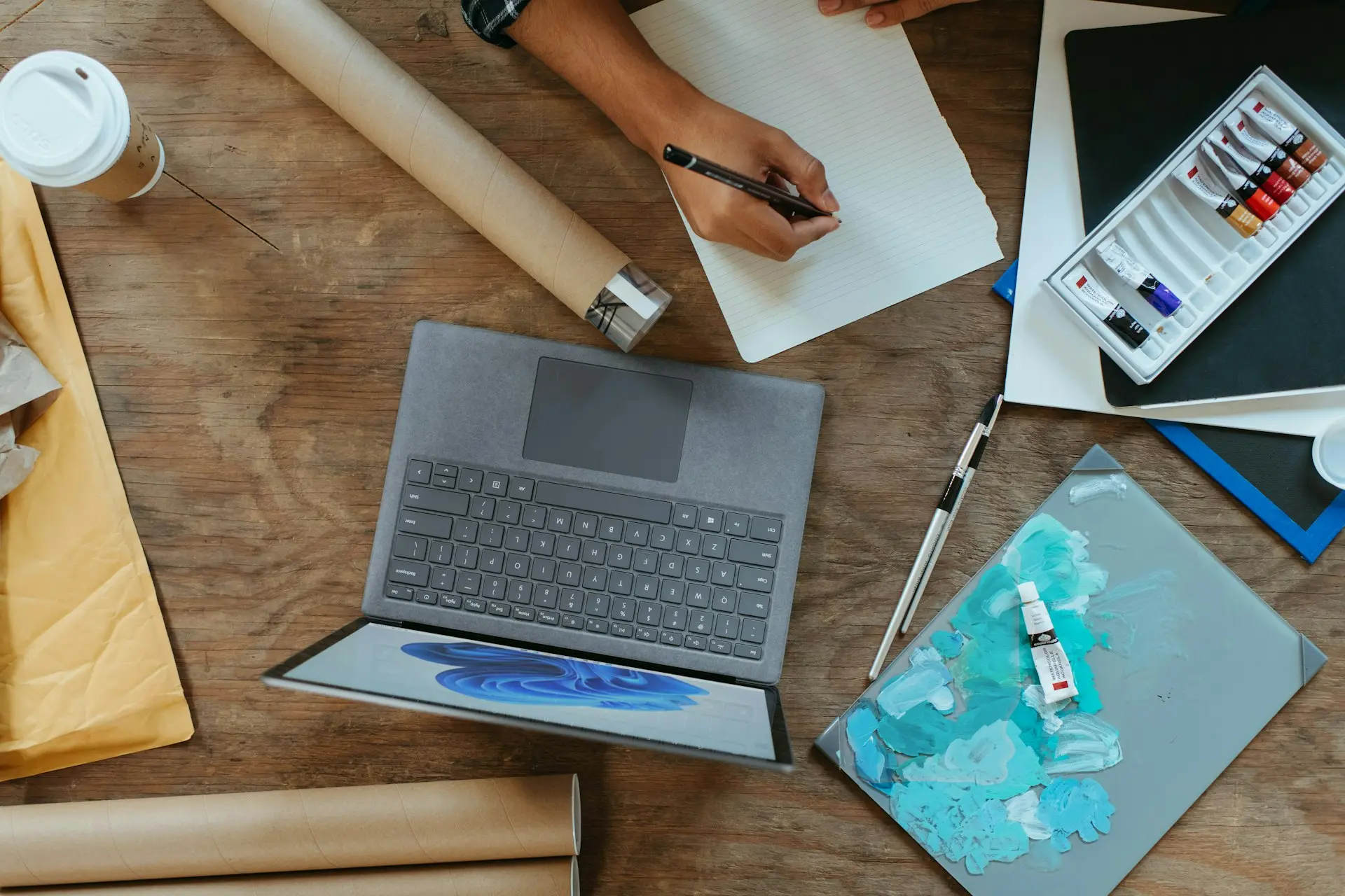 a laptop computer sitting on top of a wooden table